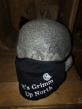 Load image into Gallery viewer, Image shows black jersey face mask printed with white text slogan saying &#39;It&#39;s Grimm Up North&#39; with the Grimm &amp; Co &#39;G&#39; monogram, mask is shown displayed on a mannequin head.
