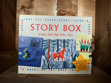 Load image into Gallery viewer, Image of the front of Story Box: Create Your Own Fairy Tales. The box has a pale cream background, with a multicoloured triangle flag border. The name is in red text at the top, with images of three of the cards features inside underneath. These are of a character riding by a castle on a scooter at night, a character riding on a horse through a forest, and three dwarfs posing for a photograph..