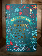 Load image into Gallery viewer, Image of the front cover of the book Shakespeare for Every Day of the Year. The cover has a dark blue/teal background with the title in the center in foiled gold text. Surrounding it are illustrations in shades of light blue and red, of plants and flowers, and objects related to Shakespeare&#39;s plays and poems, including Yorick&#39;s skull, a wine glass, a dagger, weighing scales, and fairies. 