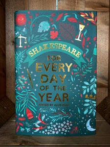 Image of the front cover of the book Shakespeare for Every Day of the Year. The cover has a dark blue/teal background with the title in the center in foiled gold text. Surrounding it are illustrations in shades of light blue and red, of plants and flowers, and objects related to Shakespeare's plays and poems, including Yorick's skull, a wine glass, a dagger, weighing scales, and fairies. 