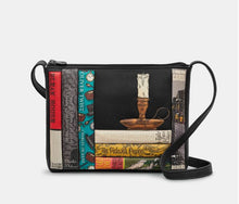 Load image into Gallery viewer, Image shows the black Yoshi leather cross-body bag themed around Charles Dickens with appliqued book spines with titles across the front. On top on a stack of books sits a candle in a candle holder. Titles include A Christmas Carol, Oliver Twist, Great Expectations and Bleak House.