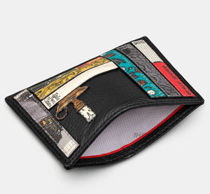 Image shows the black Yoshi leather Charles Dickens slim card holder held open to reveal the white lining printed with grey YOSHI text. Design features appliqued book spines on the front.