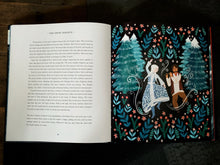 Load image into Gallery viewer, Image of a flatlay of the book Winter Tales. The book is open on pages from the story of The Snow Queen. One page is plain text, and the other is an illustration of a forest scene, with a woman dancing with a man playing a flute.