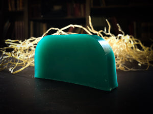Image of a Euphoria bar, a teal green solid shampoo slice shown without label