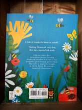 Load image into Gallery viewer, Image showing the back cover of the book Bee: Nature&#39;s Tiny Miracle. The cover shows paper cut out-style illustrations of flowers in green, white, red, and yellow, and bees and ladybirds, all on a bright blue background. The illustrations surround the blurb of the book, which is in white text.