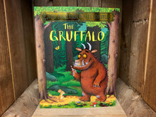 Load image into Gallery viewer, Image shows the front cover of the book The Gruffalo. The cover has a full illustration of the Gruffalo and the Mouse standing in the woods, in shades of green and brown. 