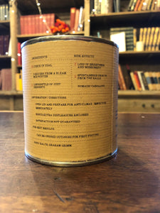 Image shows the back of a tin of Festive Disappointment with kraft paper label of faux ingredients and side effects