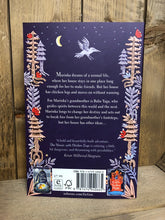 Load image into Gallery viewer, Image of the back cover of the paperback book The House with Chicken Legs featuring a purple cover and a border of forest illustrations with the blurb on the back.