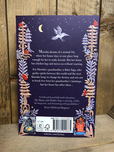 Image of the back cover of the paperback book The House with Chicken Legs featuring a purple cover and a border of forest illustrations with the blurb on the back.