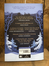 Load image into Gallery viewer, Image of the back cover of the hardback book Midnight in Everwood with a frosty blue colour and illustrations on snow covered pine trees beneath a canopy of branches and leaves.