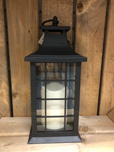 Load image into Gallery viewer, Image showing a black coloured Bright Ideas lantern with a square lattice pattern on the windows with a battery operated candle inside and a handle on the top.
