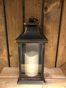 Image showing a bronze coloured Bright Ideas lantern with plain windows with a battery operated candle inside and a handle on the top.