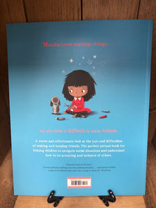 Image showing the back cover of the paperback book Meesha Makes Friends written and illustrated by Tom Percival with a bright blue cover.