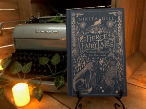 Image of hardback book Fierce Fairy Tales & Other Stories to Stir Your Soul, book is displayed on a book stand 
