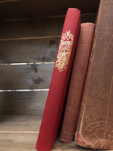 Load image into Gallery viewer, Image shows the spine of A Christmas Carol with a red clothbound cover stamped with gold foil lettering.