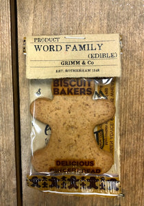 Image showing an edible Word Family Member, a mini gingerbread person made to a vegan recipe. Label features many different letters in various fonts on the back, how many words can you make from your letters?