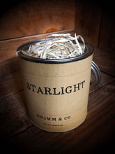 Load image into Gallery viewer, Image shows a kraft wrapped Starlight tin with the lid removed, revealing the ink box inside covered with wood wool.