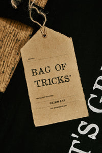 Close up of kraft paper label of black cotton tote book bag called Bag of Tricks