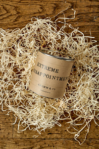 Image of Extreme Disappointment tin, labelled with kraft paper, shown on bed of wood wool