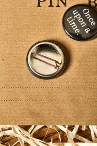 Image shows the pin fastening on the back of the button badge