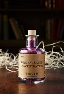 Image of Concentrated Concentration, otherwise known as scented, purple bath salts in a glass bottle with cork 