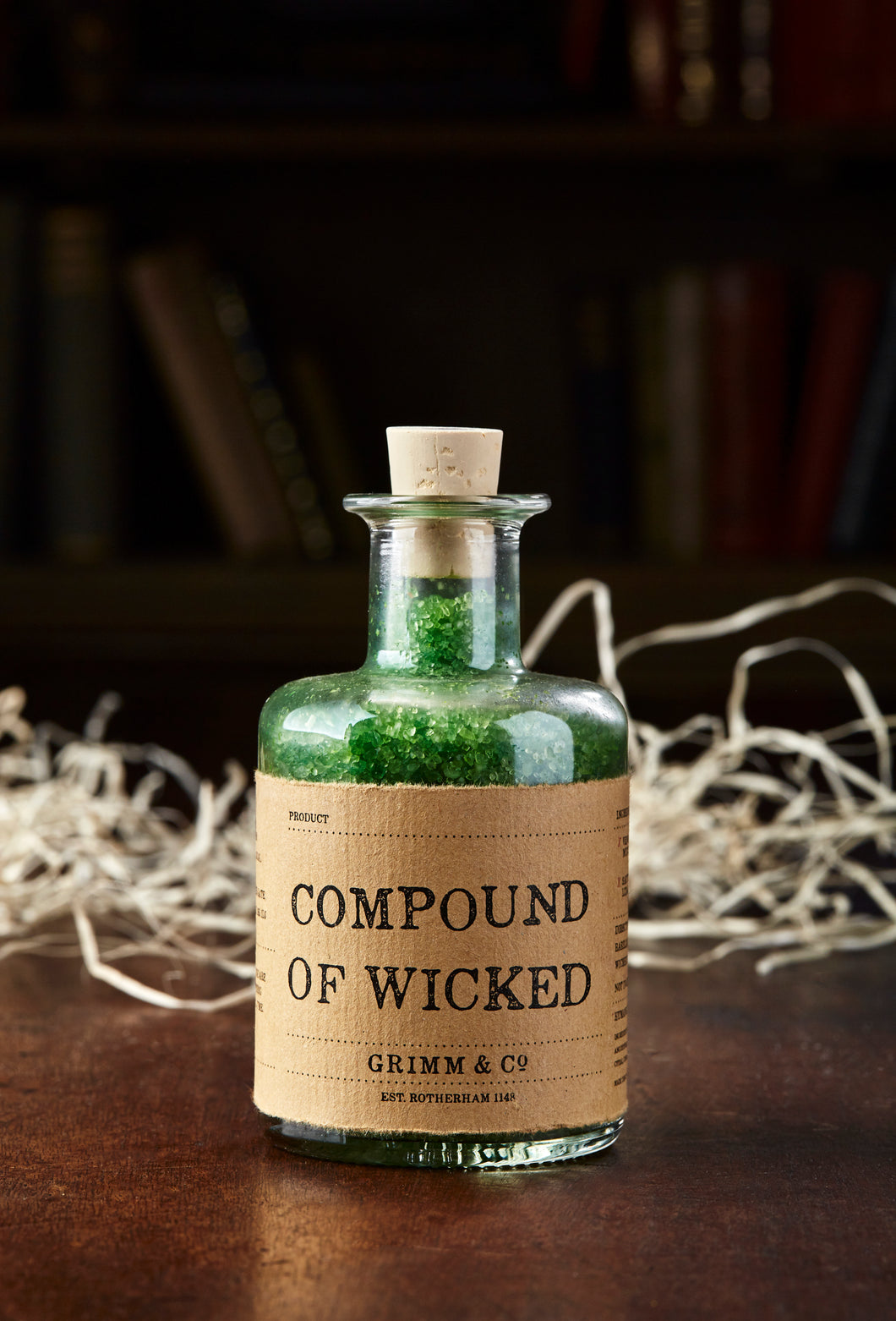 Image of Compound of Wicked, otherwise known as scented, green bath salts in a glass bottle with cork 