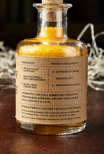 Load image into Gallery viewer, Image of the back label of A Pinch of Happiness otherwise known as scented yellow bath salts in a glass bottle with cork
