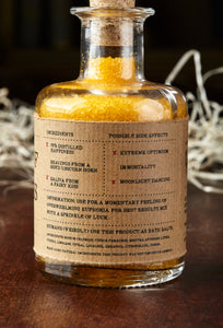 Image of the back label of A Pinch of Happiness otherwise known as scented yellow bath salts in a glass bottle with cork