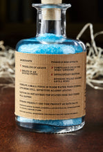 Load image into Gallery viewer, Image of the back label of Condensed Enthusiasm showing faux ingredients and side effects of bath salts in a glass bottle with cork