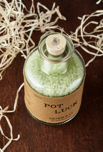 Top view image of Pot Luck, otherwise known as scented pale green bath salts in a glass bottle with cork.
