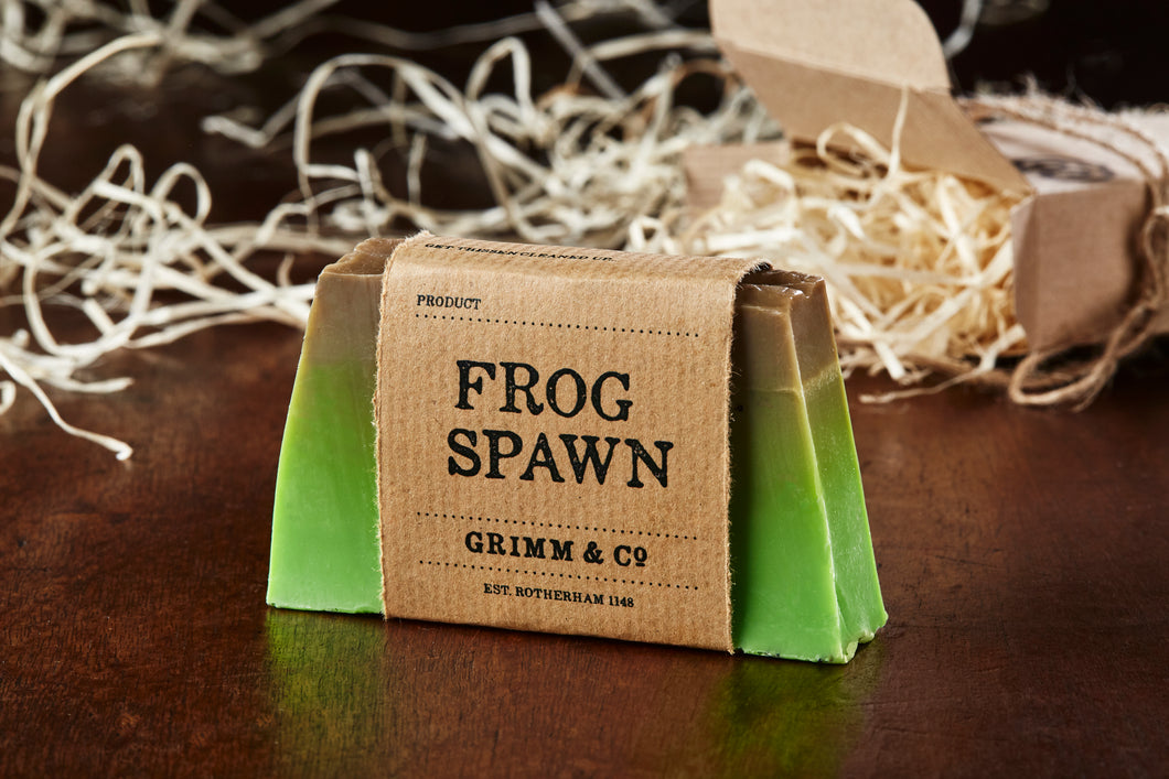 Image of Frog Spawn bar, otherwise known as a kiwi scented soap slice shown with kraft paper label
