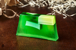 Image of Human Phlegm bar, a green and white melon scented soap slice shown without its kraft paper label.
