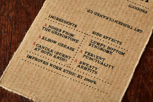 Load image into Gallery viewer, Image shows kraft paper label for Human Blood, Sweat and Tears bar, a pomegranate scented soap slice. Label lists the faux ingredients and side effects.