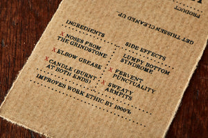 Image shows kraft paper label for Human Blood, Sweat and Tears bar, a pomegranate scented soap slice. Label lists the faux ingredients and side effects.