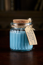 Load image into Gallery viewer, Image shows a Northern Lights Candle called Shortest Day. The candle is blue soy wax in a small glass pot with cork lid and is winter berry scented.