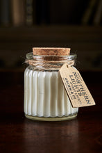 Load image into Gallery viewer, Image shows a Northern Lights Candle called First Light. The candle is white soy wax in a small glass pot with cork lid and is linen fresh scented.