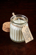Load image into Gallery viewer, Image shows a Northern Lights Candle called First Light. The candle is white soy wax in a small glass pot with cork lid and is linen fresh scented.