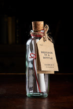 Load image into Gallery viewer, Message in a Bottle - a slim glass bottle with cork and kraft paper label containing a blank sheet of cream parchment style paper for you to write your own message on.