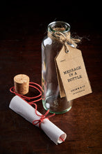 Load image into Gallery viewer, Message in a Bottle - glass bottle pictured with cork removed and paper inside lifted out but still scrolled up in red twine. 