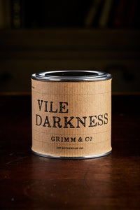 Image of a tin of Vile Darkness, otherwise known as a black drawing or writing ink, wrapped with a kraft paper label.
