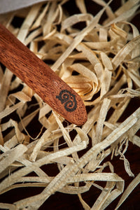 Close up detail image of the black Grimm & Co 'G' monogram imprinted into the base of the wand handle