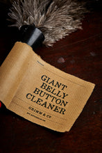 Load image into Gallery viewer, Close-up image of the Giant Belly Button Cleaner with kraft label and grey ostrich feathers attached with a black neck.