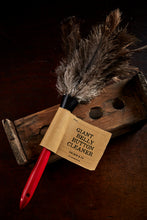 Load image into Gallery viewer, Image showing the Giant Belly Button Cleaner with red wooden handle, kraft label and grey ostrich feathers at the end of the handle fastened with a black plastic ring.