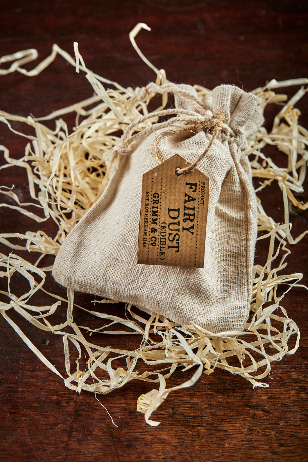 Image of a linen drawstring pouch labelled Edible Fairy Dust with a kraft paper label 