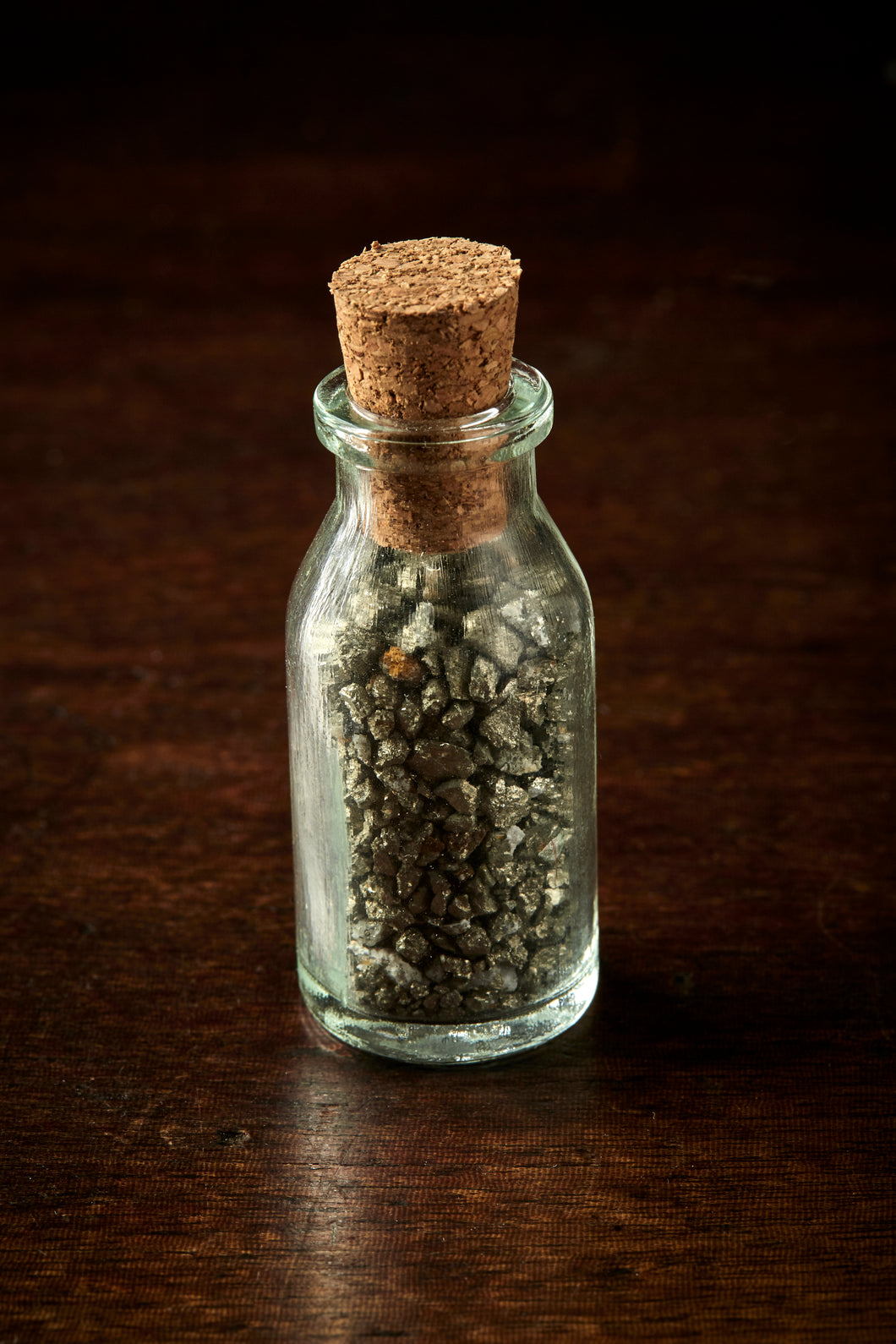 Mini glass bottle with cork containing Leprechaun Gold, otherwise known as iron pyrite or fool's gold pieces