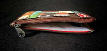 Load image into Gallery viewer, Image shows the brown Yoshi leather zip coin purse qith the zipper open showing the white cotton lining inside printed with repeat Yoshi branding in grey.