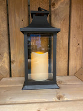 Load image into Gallery viewer, Image showing a black coloured Bright Ideas lantern with plain clear windows with a battery operated candle inside and a handle on the top.