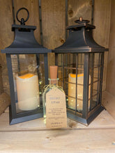 Load image into Gallery viewer, Image showing the different items in the Bright Ideas range including two lanterns, one black one bronze with different lattice window patterns and a Bright Ideas Bottle with LED string lights on a cork style stopper.
