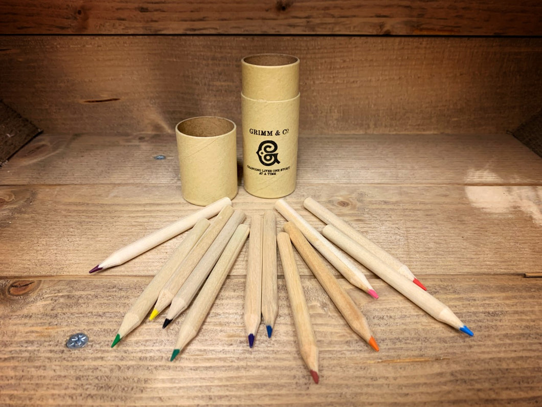 Image shows the Rainbow Word Wand Tube with the lid removed and all 12 coloured pencils laid out in front. Pencil shafts are all natural wood.