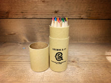 Load image into Gallery viewer, Image shows the Rainbow Word Wand Tube with the lid removed to display the coloured pencils stood inside the tube. Tube is kraft and printed with Grimm &amp; Co and the &#39;G&#39; monogram and the words Changing lives one story at a time.